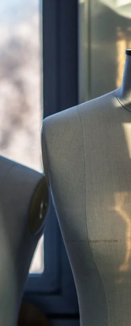 Two mannequins in a fashion design studio, illuminated by natural light from a window. Two mannequins in a fashion design studio, illuminated by natural light from a window.